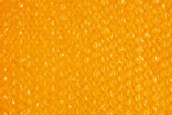 Fundo de plástico textura celofane embalagem embalagem envoltório pacote talão bola brilhante laranja amarelo quente sol — Fotografia de Stock
