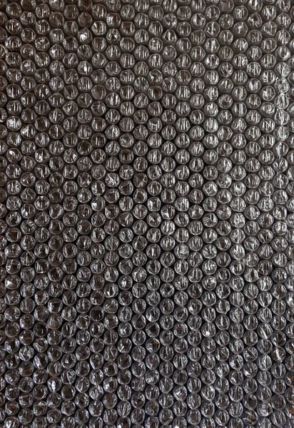 Plast bakgrund textur cellofan inslagning förpackning wrap paket pärla boll vit svart grå metall silver — Stockfoto