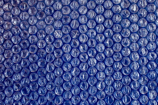 Fundo de plástico textura celofane embalagem embalagem envoltório pacote talão bola brilhante céu azul indigo cor ciano — Fotografia de Stock
