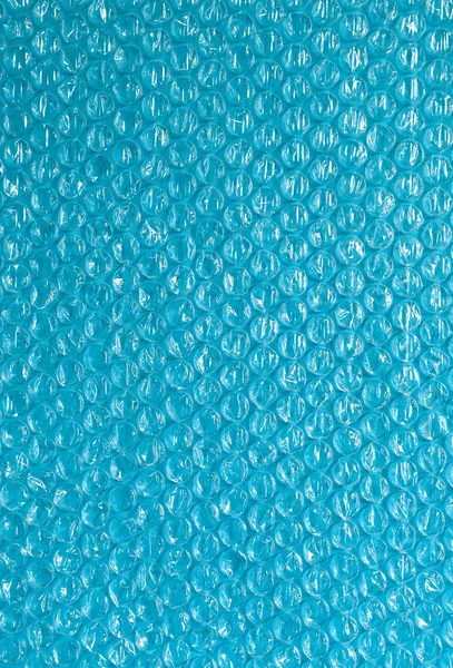 Fundo de plástico textura celofane embalagem embalagem envoltório pacote talão bola brilhante céu azul indigo cor ciano — Fotografia de Stock