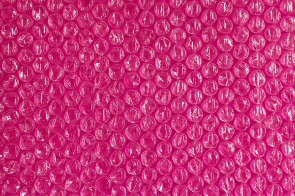 Пластиковий фон текстури целофану упаковки упаковки упаковки з бісеру кульки фіолетовий рожевий рожевий бузковий червоний — стокове фото