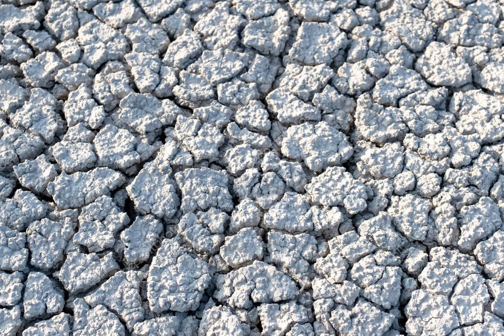 dry land cracks grey gray grayscale earth ground dried cracking background landscape terraine hilly surface