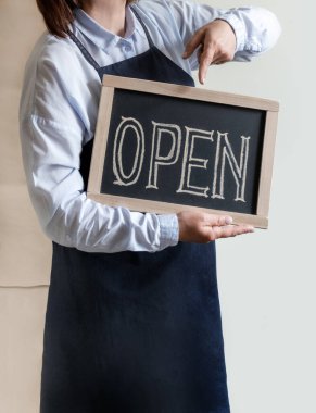 Kadın Elleri Metni Açık Gösterge Paneli Tutuyor. Önlüklü İşçi Kafe ya da Market Açılışını Gösteriyor.