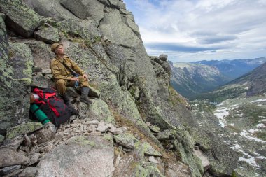 Bir adam bir kaya üzerine onun susuzluk quenches ve güzel manzara sahiptir. Adam onun hedefi elde.