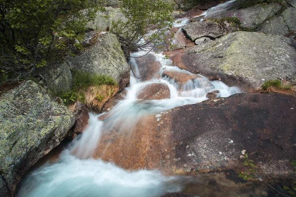 Mountain waterfall. Very beautiful landscape with mountain waterfall and pure mountain river