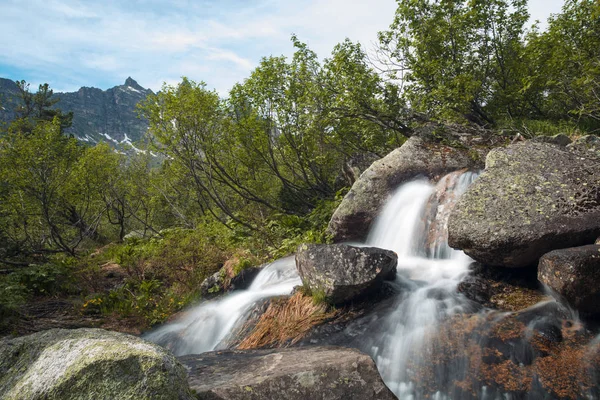 Mountain waterfall. Very beautiful landscape with mountain waterfall and pure mountain river