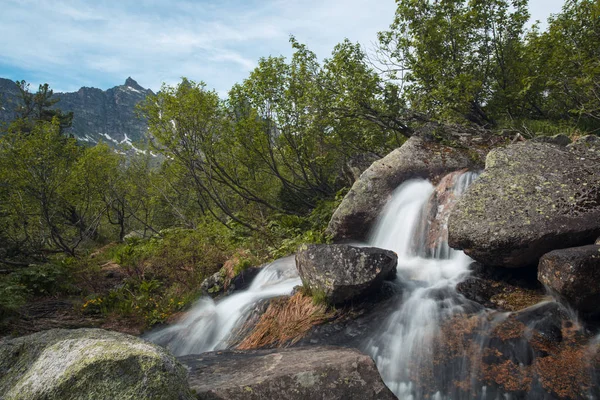 Mountain waterfall. Very beautiful landscape with mountain waterfall and pure mountain river