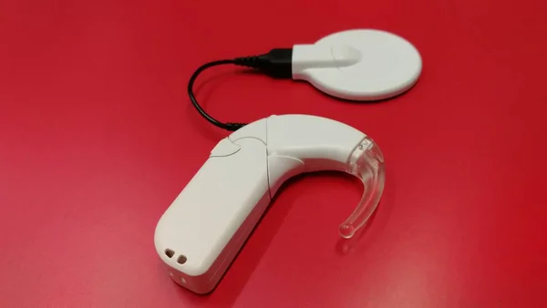 ochlear implant for deaf people with hearing loss and with a hearing aid