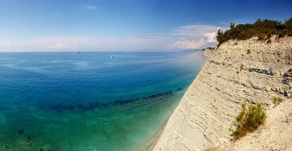 steep steep cliffs, pine trees, yacht in the clear sea, the coast of Gelendzhik, Sosnovka beach, Gelendzhik, Black sea