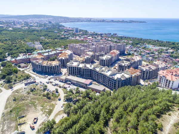 Construction of residential high-rise buildings in Gelendzhik on the shore of Gelendzhik Bay. At the foot of the Caucasus mountains on the Black sea in the resort town of Gelendzhik is the construction of a residential complex.