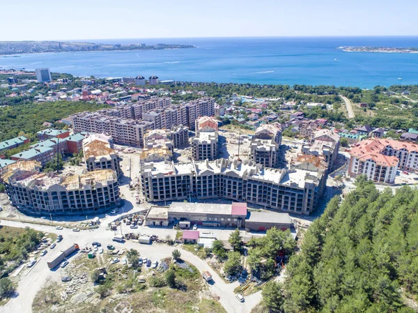 Construction of residential high-rise buildings in Gelendzhik on the shore of Gelendzhik Bay. At the foot of the Caucasus mountains on the Black sea in the resort town of Gelendzhik is the construction of a residential complex.