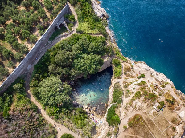 Bird View of Natural swimming pool called Regina Giovanna in Sorrento with natural rock bridge, Italy. Ruins of a large Roman vila from 1st Century AC