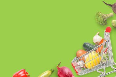 Vegetables and cart on green table with copy space. clipart