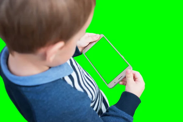 Kid holding smart phone in horizontal position. Isolated screen and background in green, chroma key.