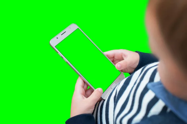 Boy play game on smart phone. Isolated screen and background in green for video editors.