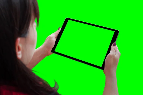 Woman holding tablet with isolated screen in horizontal position. Isolated in green, chroma key.