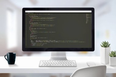 Ekranda JavaScript kodu ile web geliştirici bilgisayar. Arka planda ofis ile çalışma masası yakın çekim sahnesi. 