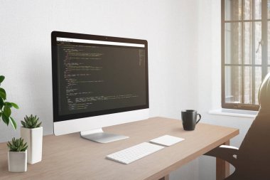 Freelancer işyeri kavramı. Açık kod düzenleyicisiyle bilgisayar ekranı. Tesisler ve masada bir fincan kahve.