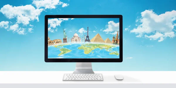 Computer display with globe and famous world sights on white desk. Concept of booking and planning holiday online. Sky and clouds in background.