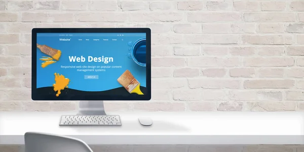 Clean web designer desk with computer display and modern flat design web site teme with web design text. Copy space beside on brick wall.