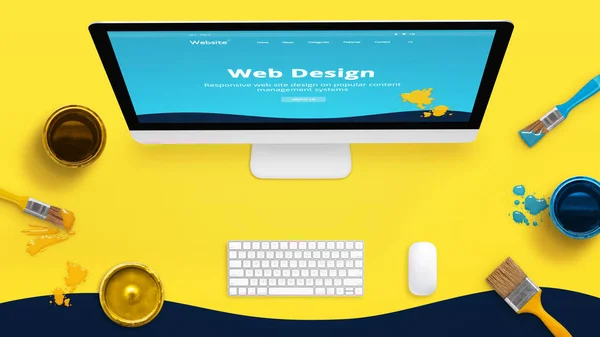Creative yellow web design studio desk with color brushes and boxes and painted web theme layout on a computer display.
