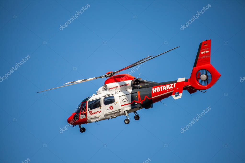 Remagen, Germany-September 2019: Rescue Helicopter from German  Johanniter Hair Rescuers  fly on blue sky