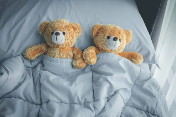 couple love bear doll lying on bed room, feel like happy and low