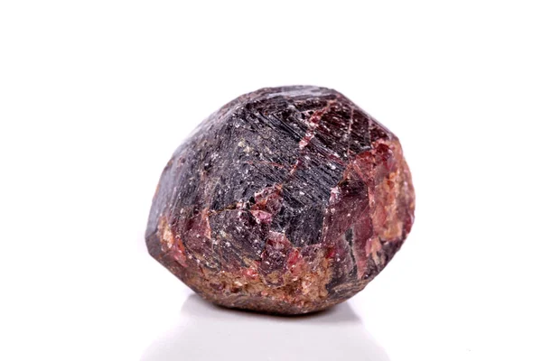 Macro of a mineral garnet stone on a white background close up