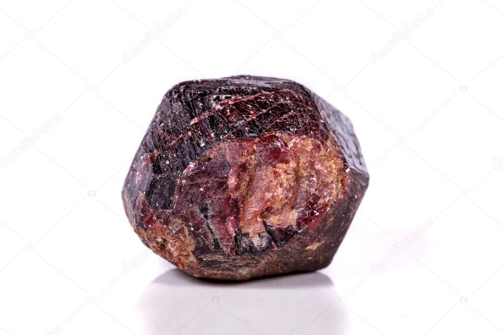 Macro of a mineral garnet stone on a white background close up