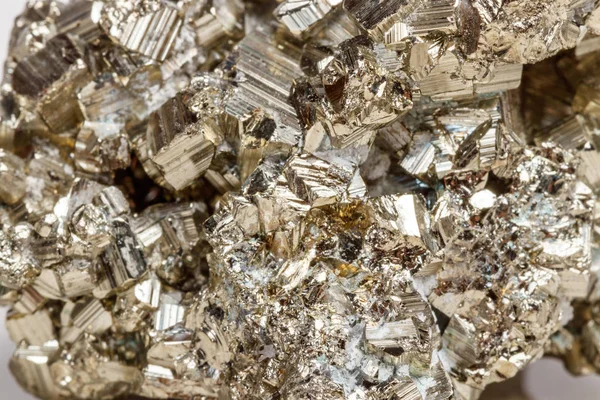 Macro mineral stone Pyrite gold on white background close up