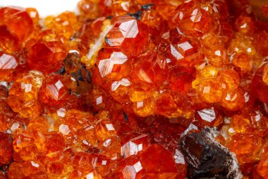 macro mineral stone Spessartine, orange, red garnet with quartz on white background close-up clipart