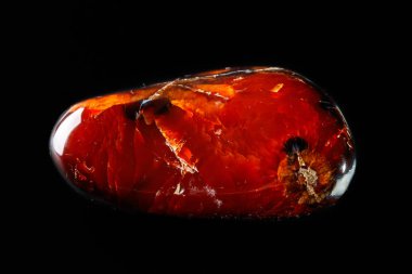 Macro mineral stone Cornelian on a black background close up clipart