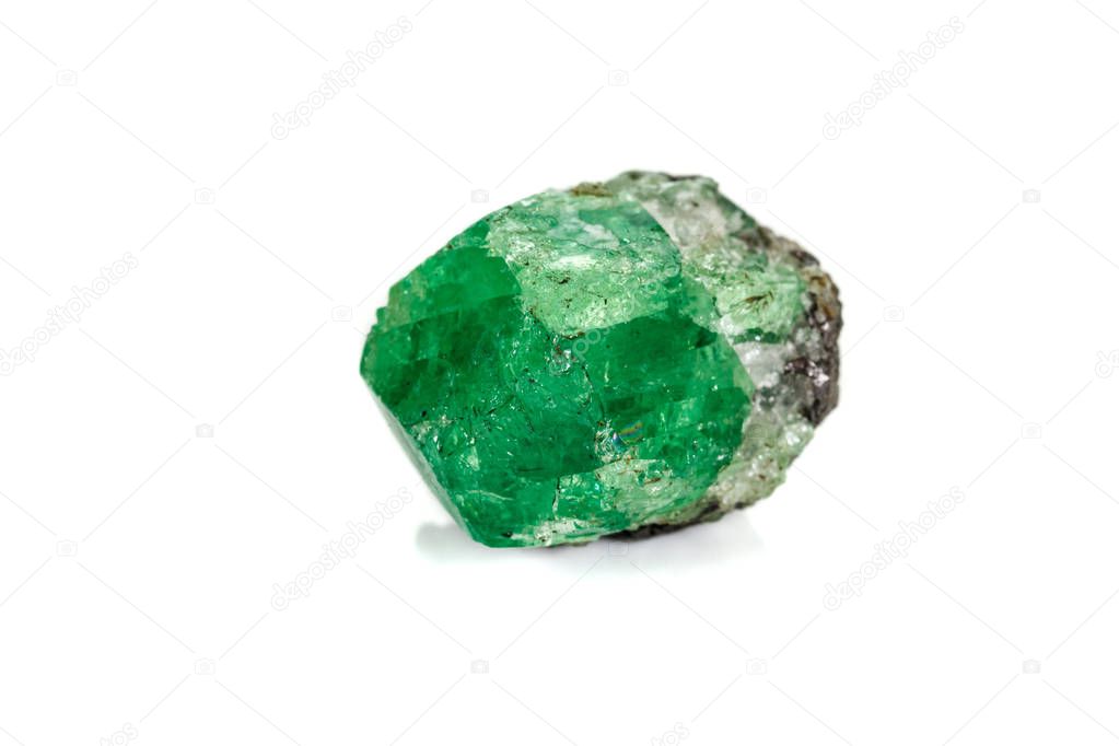 Macro stone garnet mineral, Uvarovite in rock on a white backgro