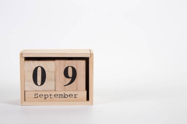 Wooden calendar September 09 on a white background 
