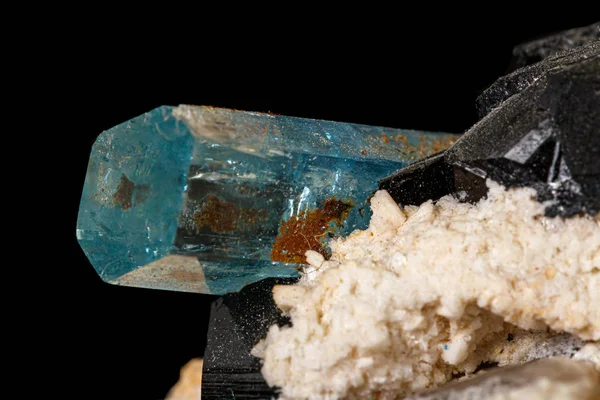 Macro stone mineral tourmaline aquamarine with a black backgroun