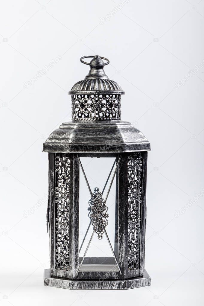 Beautiful vintage metal lantern on a white background 