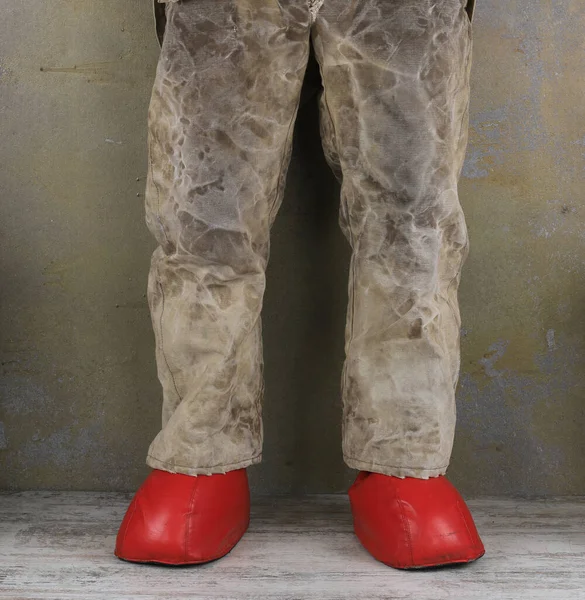 man in old pants and red slippers