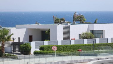 modern resort villas with palm trees and greenery