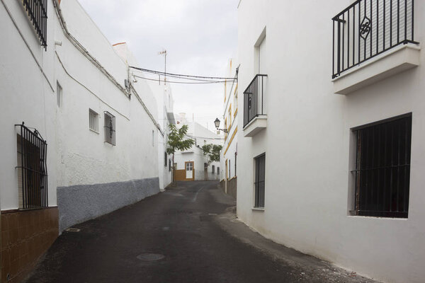 Facades of white houses in city of Conil de la Frontera, Spain