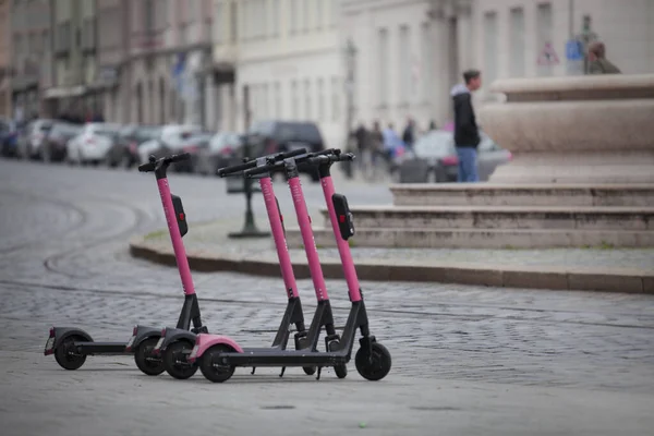 Elektrikli scooterlar yağmurda yolda.