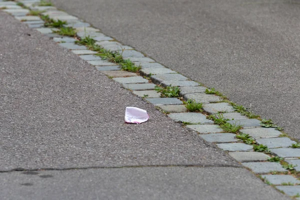 lost face mask lies in the street