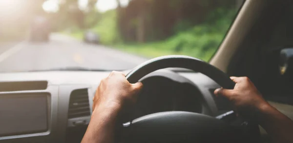 closeup hand driver car on road