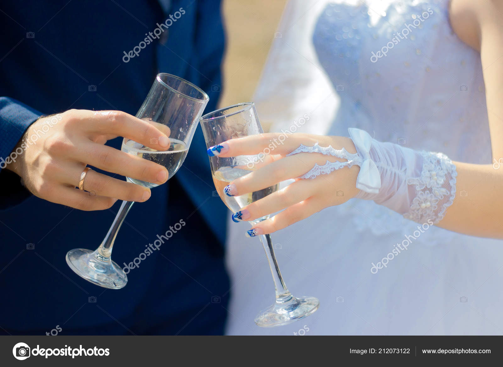 Bride And Groom Holding Beautifully Decorated Wedding Glasses With