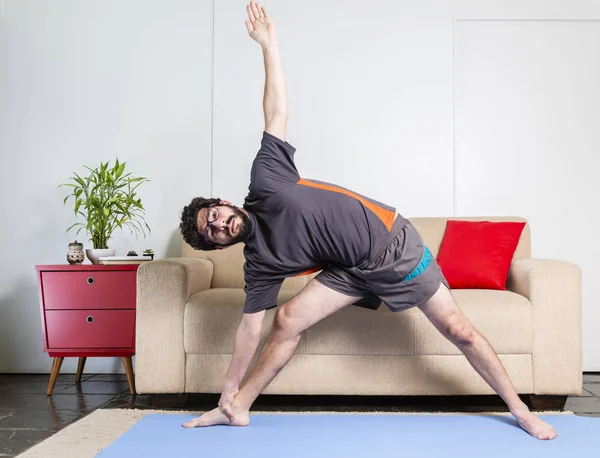 Beautiful Caucasian Bearded Man Black Clothes Blue Yogamat Doing Triangle — Stock Photo, Image