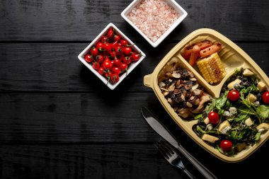 Salata ve tavuk şeritler karamelize soğan ve badem ile. Havuç ve Mısır. Brezilyalı beslenme çantası. üstten görünüm