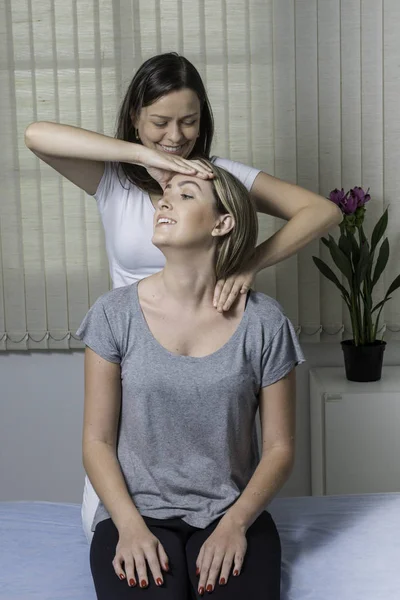 Blond Woman having chiropractic adjustment. Osteopathy, Alternative medicine, pain relief concept. Physiotherapy, sport injury rehabilitation.