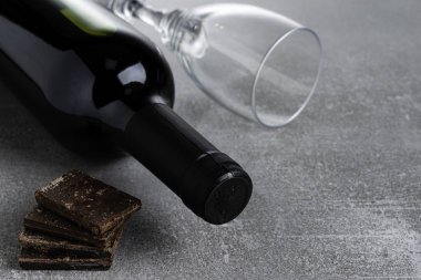 Beton arka planda şarap ve çikolata. Boşluğu Kopyala.