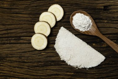 Beiju of tapioca, cassava-based dish typical of the northeastern region of Brazil, now consumed in the whole country on old wooden background.