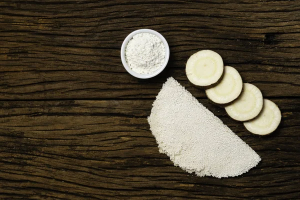 Beiju of tapioca, cassava-based dish typical of the northeastern region of Brazil, now consumed in the whole country on old wooden background.