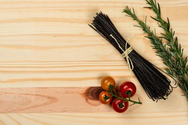 Çam arka planda doğal siyah fasulye spagetti. Yemek pişirmek için hazır.